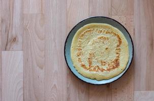 Freshly baked pancake or batter cake on a plate photo
