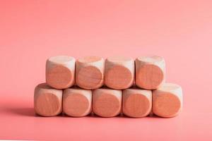 blank wooden dice for inserting text.on pink background photo