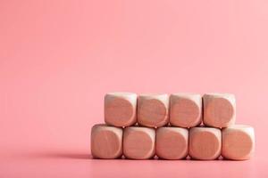 blank wooden dice for inserting text.on pink background photo