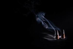 frankincense with white smoke on black background photo