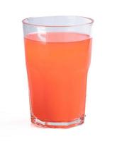 Orange juice drink mixed with mixed fruit in a clear glass photo