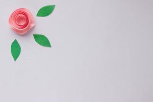 Banner with origami rose and paper leaves with place for your design. Paper background photo