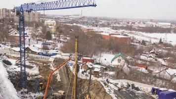 NOVOSIBIRSK, RUSSIAN FEDERATION MARCH 14, 2021 - Initial stage of building construction. Construction machinery and workers, top view