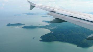 Aerial view over group of island in Andaman sea near Phuket, southern part of Thailand, view from descending airplane video