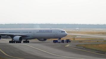 FRANKFURT AM MAIN, GERMANY JULY 20, 2017 - South African Airbus 340 ZS SNG being towed by tractor from maintenance parking in Fraport video