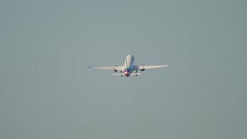 Long shot footage of an unrecognizable passenger aircraft climbing away. Tourism and travel concept video