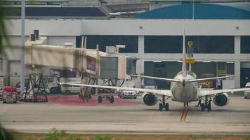 PHUKET, THAILAND DECEMBER 1, 2016 - NOK Air Boeing 737 HS DBV taxiing end after landing. View from the top floor of the hotel Centara Grand West Sands Resort Phuket video
