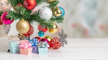 christmas balls and snowflake with blue bell hanging on the branch of the pine photo