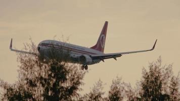 PHUKET, THAILAND NOVEMBER 27, 2019 - Malaysian Airline System Boeing 737 9M MXA in 40th anniversary of Malasian hospitality livery landing at Phuket international airport. video