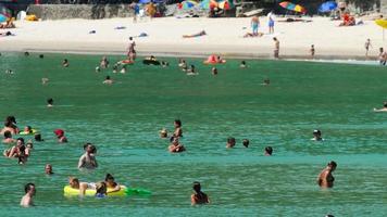 PHUKET, THAILAND NOVEMBER 19, 2018 - Vacationers people, tourists in the waves on the Nai Harn beach video