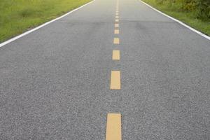 Rural paved road with nature on either side and the sunlight. photo