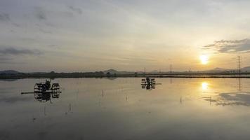 Timelapse sun rise over reflection of tractor video