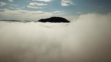 Aerial move towards Bukit Mertajam hill with 4 communication towers video