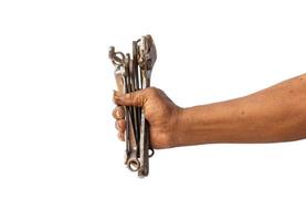 A man holds old and rusty tools for mechanic work photo