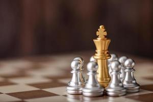 gold king standing in the midst of chess on board photo