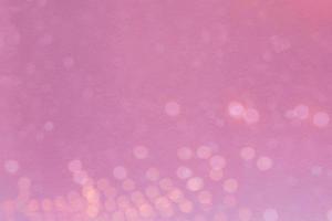 Abstract blurred light bokeh on pink background photo