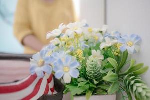 Close up blur the women in the mirror and flowers with pollen on the dressing table photo