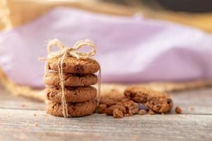 Stacked cookies use a rope tied on a wooden table photo