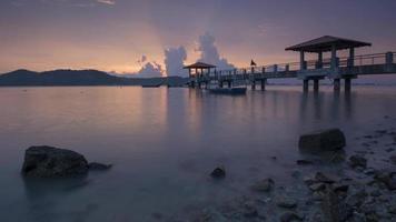 Sunset jetty with colorful ray after rain. video