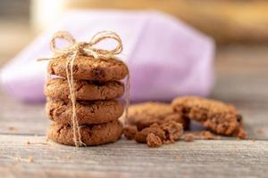 Stacked cookies use a rope tied on a wooden table photo