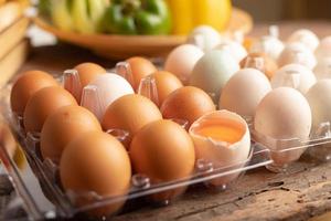 Close up eggs of chicken and duck placed on a wooden table photo