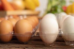 eggs of duck and chicken are placed on a wooden table photo
