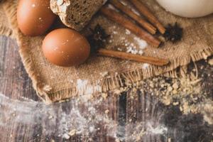 Cinnamons and eggs are placed on the sack and the flour photo