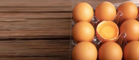 Eggs of chicken and yolk with broken in plastic box photo