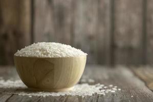 Rice in a brown bowl on the wooden table photo