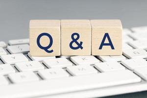 Q and A word on wooden block on computer keyboard. Questions and answers concept photo