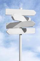 Blank white signpost on blue sky background. Choose the correct way concept. Mock up, template photo