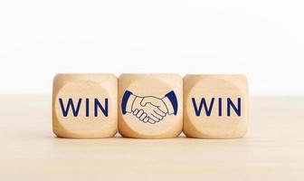 Win Win concept. Text and handshake Icon on wooden blocks. Copy space photo