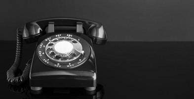 Black Retro telephone on dark background. Copy space photo