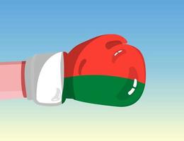 Flag of Madagascar on boxing glove. Confrontation between countries with competitive power. Offensive attitude. Separation of power. Template ready design. vector