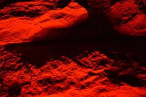 A red illuminated brick wall photo