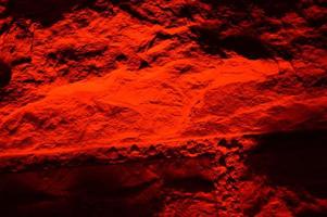 A red illuminated brick wall photo