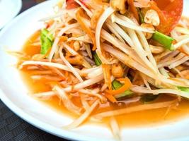 Spicy Thai Papaya Salad in the white plate photo