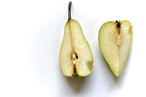 Sliced green pear in half on a white background photo