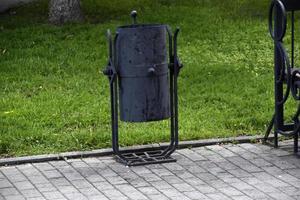 A trash can on the street with a place for cigarettes photo