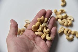Fruits delicious cashew nuts in hand close-up photo