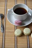 Tea pair with fragrant tea and pasta on a wooden mat. photo
