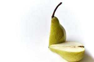 Sliced green pear in half on a white background photo