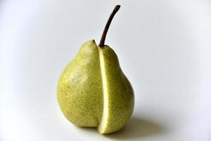 Sliced green pear in half on a white background photo