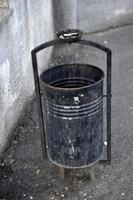 A trash can on the street with a place for cigarettes photo