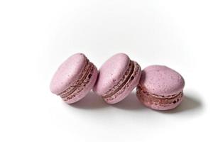 Delicious multicolored almond cookies isolated on a white background. Sweet multicolored macaroons. photo