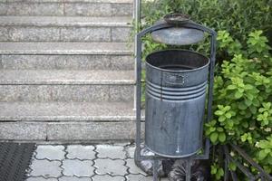 A trash can on the street with a place for cigarettes photo