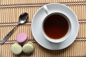 Tea pair with fragrant tea and pasta on a wooden mat. photo