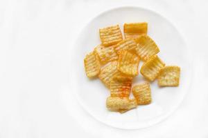 Delicious potato chips with pepper on a white plate photo