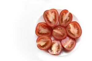 Sliced red tomato on a white plate photo