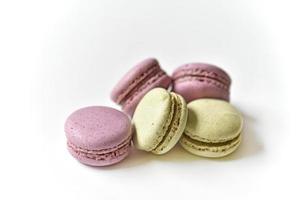 Delicious multicolored almond cookies isolated on a white background. Sweet multicolored macaroons. photo